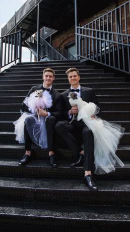 Tika and Kala sit gracefully with their dads