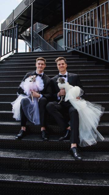 Tika and Kala sit gracefully with their dads