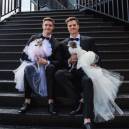 Tika and Kala sit gracefully with their dads