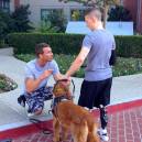 Brandon McMillan working with a service dog and wounded veteran