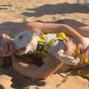 Larissa Wohl on the beach with a foster dog from Maui Humane Society 